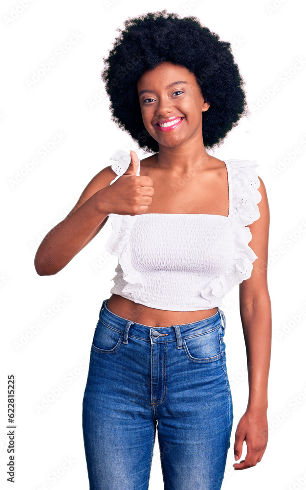 Young african american woman wearing casual clothes doing happy thumbs up gesture with hand. approving expression looking at the camera showing success. Young african american woman wearing casual clothes doing happy thumbs up gesture with hand. approving expression looking at the camera showing success.