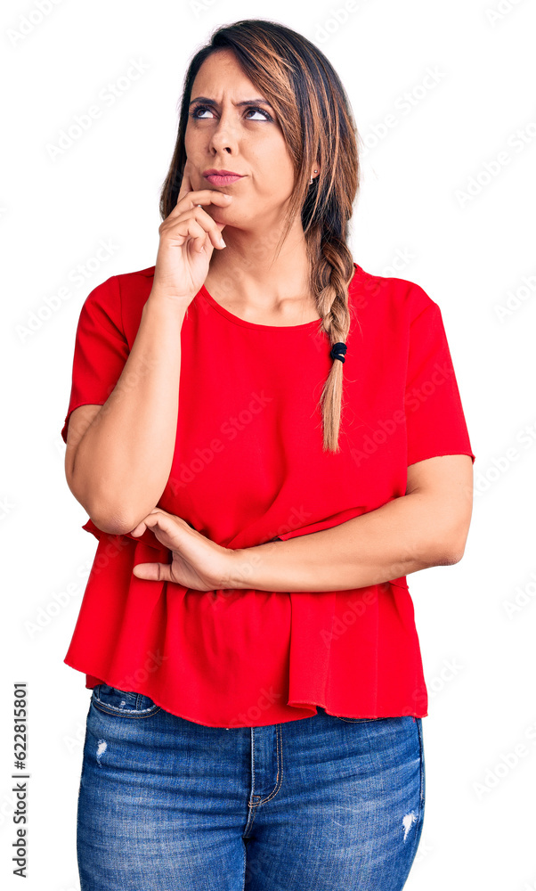 Young beautiful woman wearing casual t-shirt serious face thinking about question with hand on chin, thoughtful about confusing idea Young beautiful woman wearing casual t-shirt serious face thinking about question with hand on chin, thoughtful about confusing idea