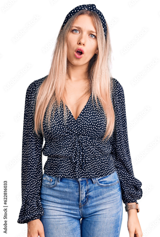 Young beautiful blonde woman wearing casual clothes in shock face, looking skeptical and sarcastic, surprised with open mouth Young beautiful blonde woman wearing casual clothes in shock face, looking skeptical and sarcastic, surprised with open mouth