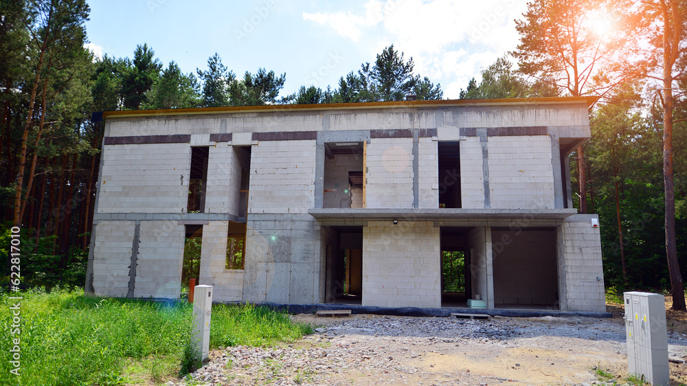 Single modern house under construction. A building on the edge of the forest.