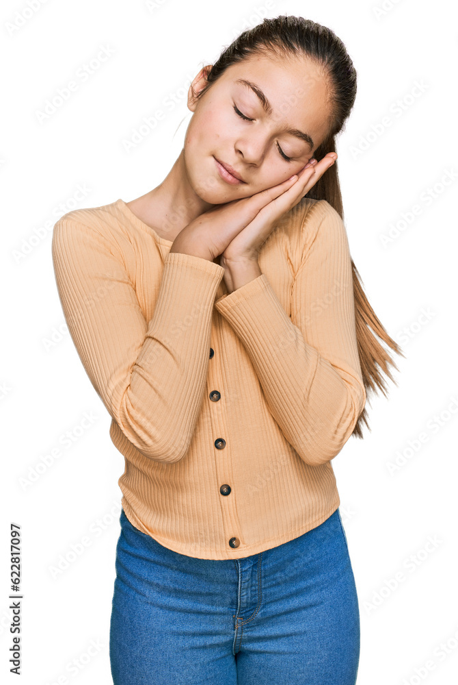 Beautiful brunette little girl wearing casual sweater sleeping tired dreaming and posing with hands together while smiling with closed eyes. Beautiful brunette little girl wearing casual sweater sleeping tired dreaming and posing with hands together while smiling with closed eyes.