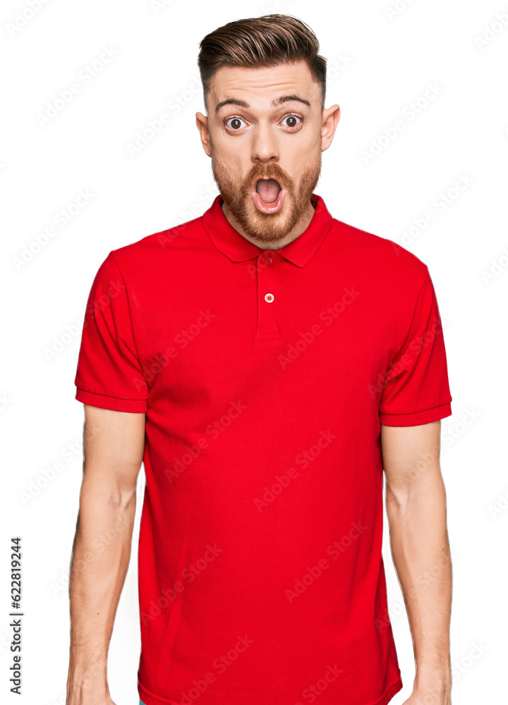 Young redhead man wearing casual clothes afraid and shocked with surprise expression, fear and excited face. Young redhead man wearing casual clothes afraid and shocked with surprise expression, fear and excited face.