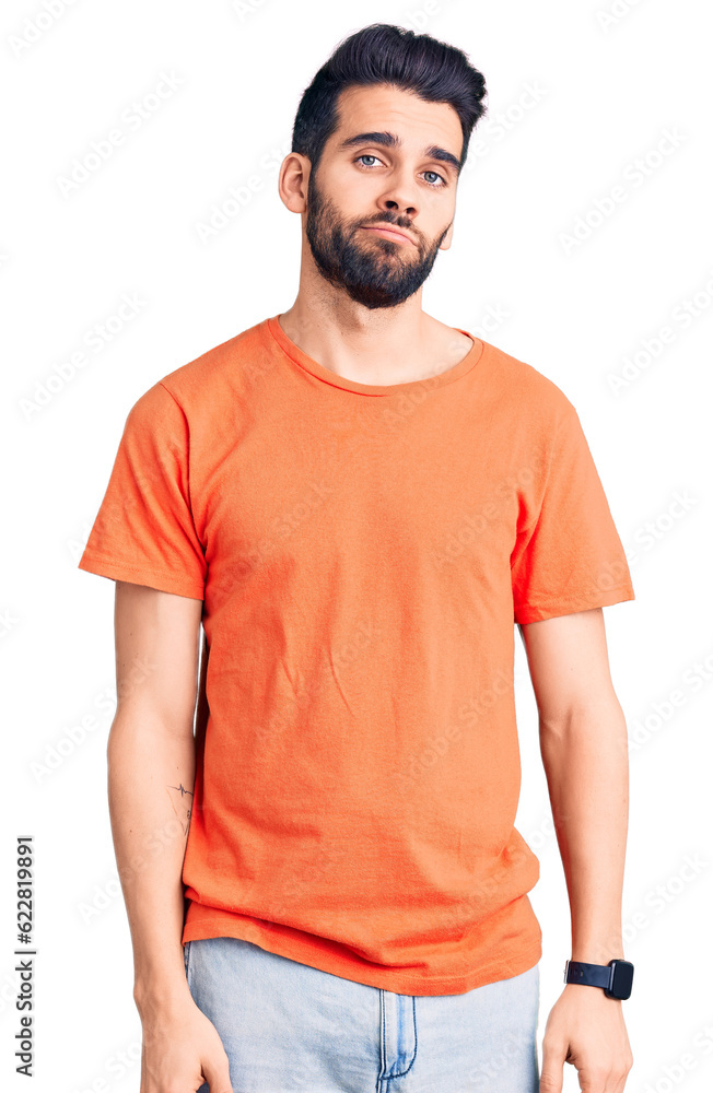Fototapeta premium Young handsome man with beard wearing casual t-shirt looking sleepy and tired, exhausted for fatigue and hangover, lazy eyes in the morning.