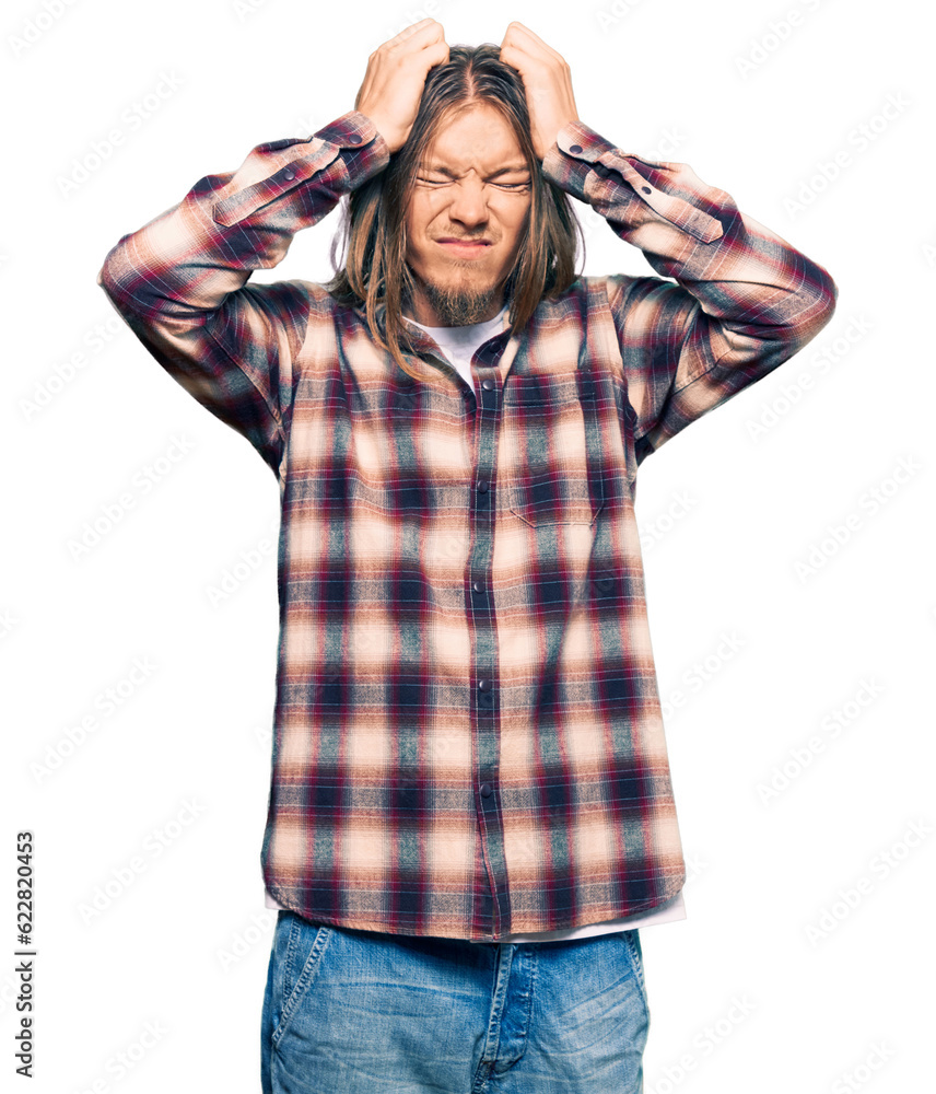 Handsome caucasian man with long hair wearing hipster shirt suffering from headache desperate and stressed because pain and migraine. hands on head. Handsome caucasian man with long hair wearing hipster shirt suffering from headache desperate and stressed because pain and migraine. hands on head.