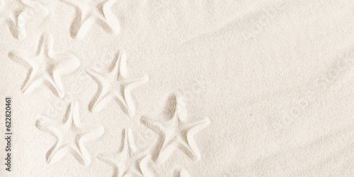 Texture of beach sand with seashells imprint. Starfish imprint on sand. Seashells on sand beach