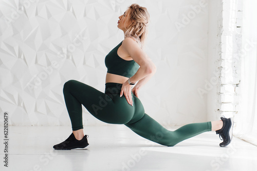 Full length shot of fit young woman doing stretching workout