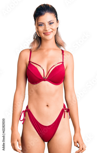 Young beautiful woman wearing bikini with a happy and cool smile on face. lucky person. © Krakenimages.com