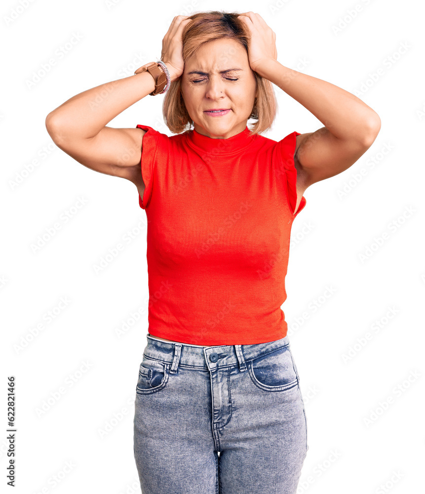 Young blonde woman wearing casual clothes suffering from headache desperate and stressed because pain and migraine. hands on head. Young blonde woman wearing casual clothes suffering from headache desperate and stressed because pain and migraine. hands on head.