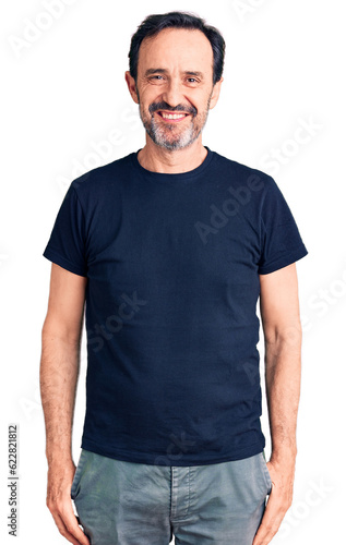 Middle age handsome man wearing casual t-shirt with a happy and cool smile on face. lucky person.