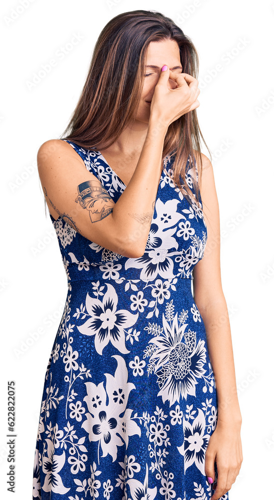 Beautiful caucasian woman wearing summer dress tired rubbing nose and eyes feeling fatigue and headache. stress and frustration concept. Beautiful caucasian woman wearing summer dress tired rubbing nose and eyes feeling fatigue and headache. stress and frustration concept.