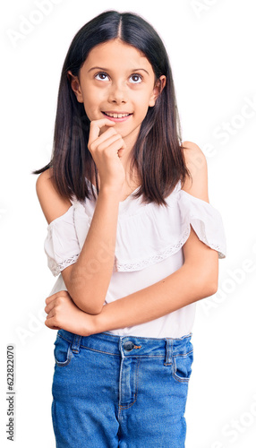 Beautiful child girl wearing casual clothes looking confident at the camera with smile with crossed arms and hand raised on chin. thinking positive.