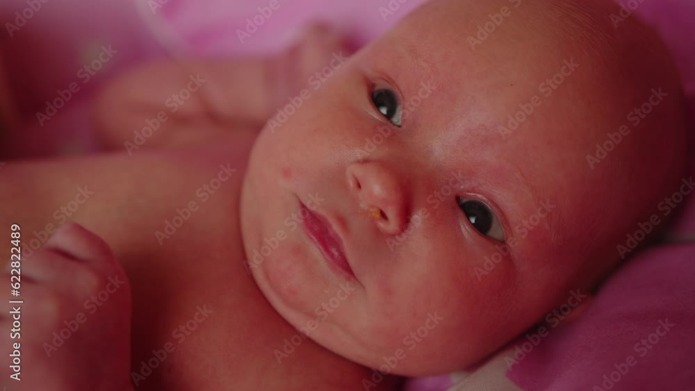 Cute newborn baby is lying in the crib, first days of life Cute newborn baby is lying in the crib, first days of life