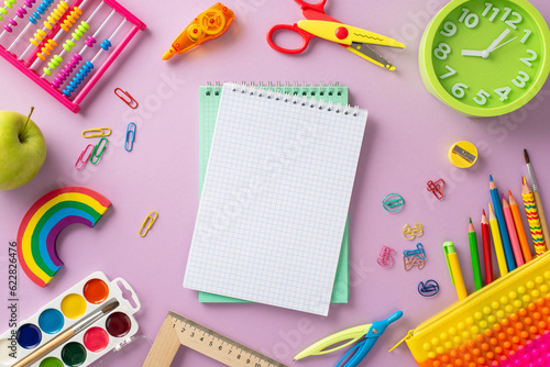 Embark on a captivating learning adventure with this creative top-down snapshot: a vivid array of child stationery on pastel purple background, blank notebook page for text or promotional material