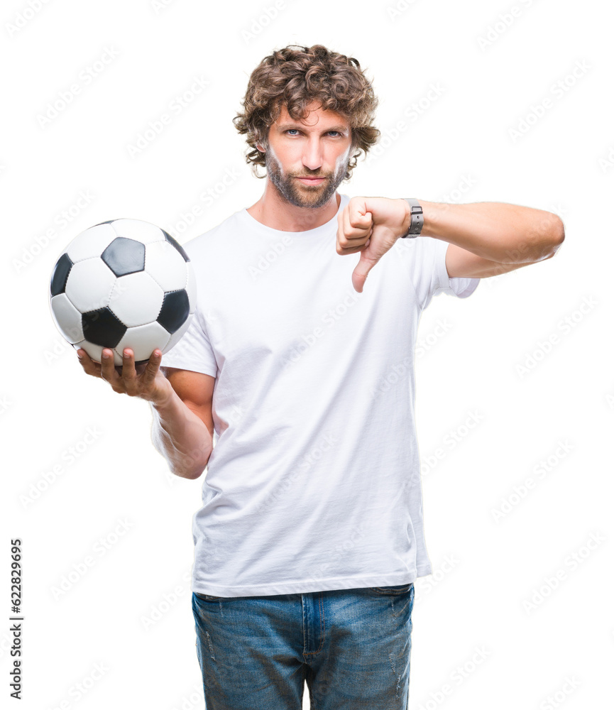 Obraz premium Handsome hispanic man model holding soccer football ball over isolated background with angry face, negative sign showing dislike with thumbs down, rejection concept