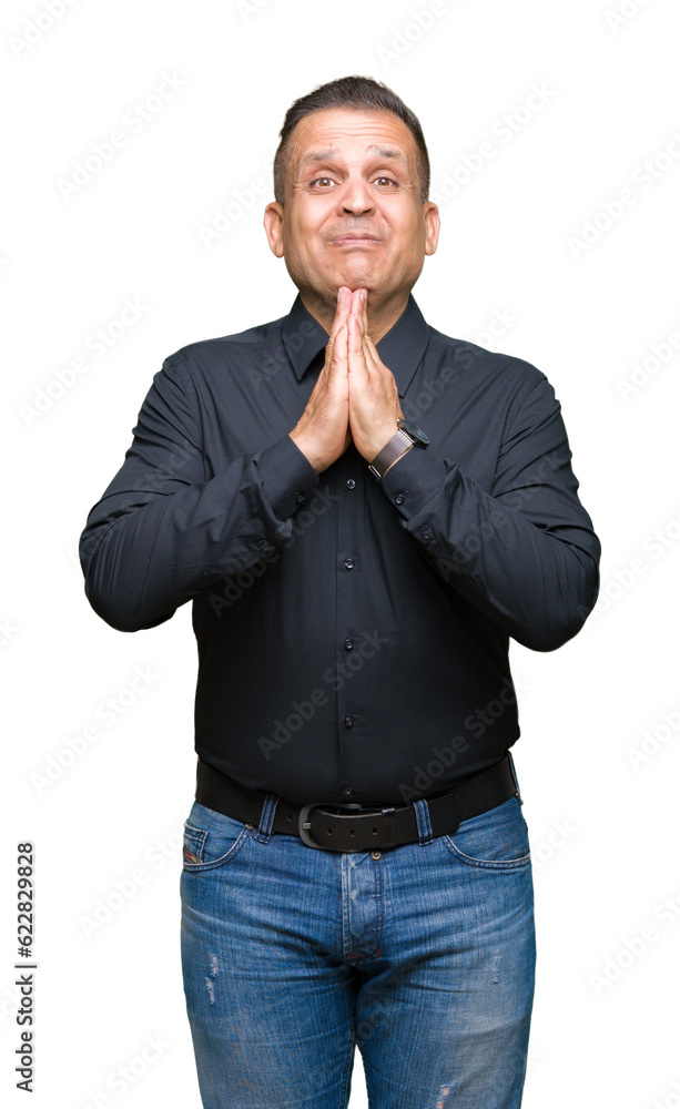 Handsome middle age arab business man over isolated background praying with hands together asking for forgiveness smiling confident. Handsome middle age arab business man over isolated background praying with hands together asking for forgiveness smiling confident.