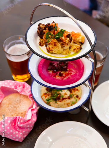 Fresh portions of different types of meze dishes served on table.