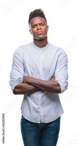 Young african american man over isolated background skeptic and nervous, disapproving expression on face with crossed arms. Negative person. © Krakenimages.com