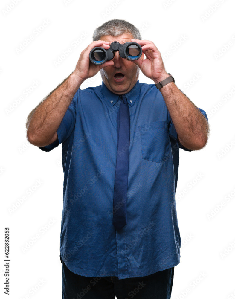 Handsome senior man looking through binoculars over isolated background scared in shock with a surprise face, afraid and excited with fear expression Handsome senior man looking through binoculars over isolated background scared in shock with a surprise face, afraid and excited with fear expression