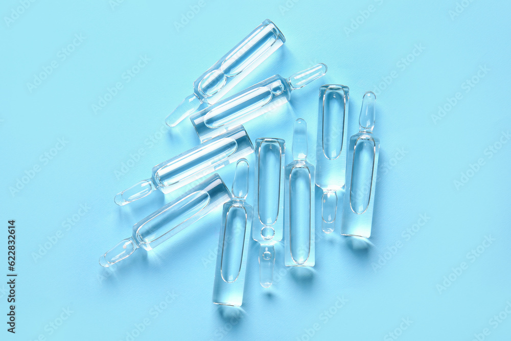 Naklejka premium Medical ampules on blue background