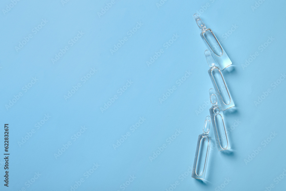 Medical ampules on blue background Medical ampules on blue background