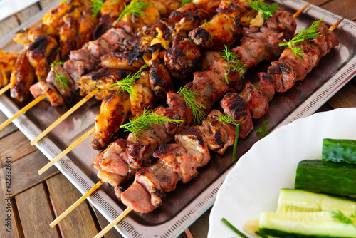 Top view of tasty shish kebab from pork and chicken on a tray. High quality photo