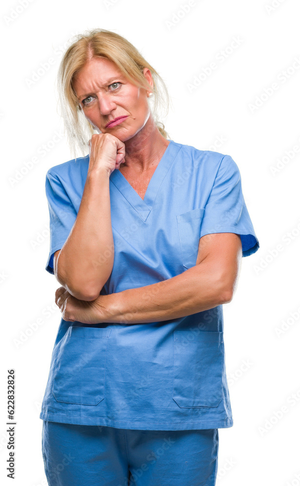 Middle age blonde woman wearing doctor nurse uniform over isolated background thinking looking tired and bored with depression problems with crossed arms. Middle age blonde woman wearing doctor nurse uniform over isolated background thinking looking tired and bored with depression problems with crossed arms.