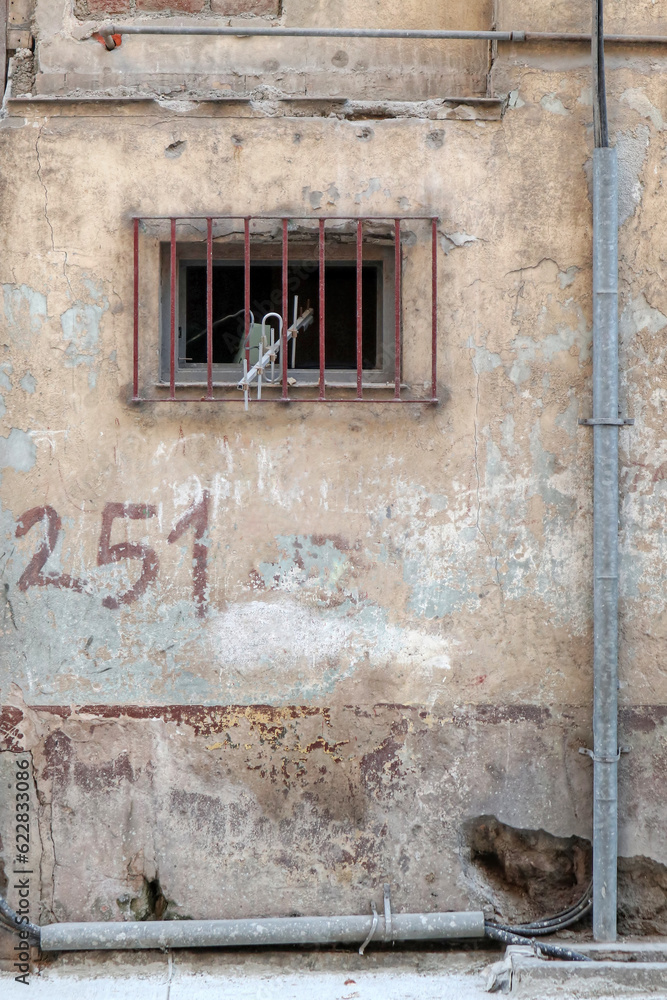 A photo of old facade with window and gutter 