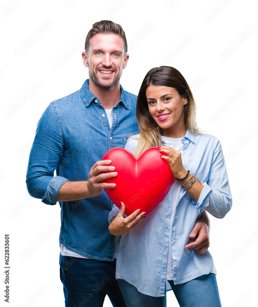 Young couple in love holding red heart over isolated background with a happy face standing and smiling with a confident smile showing teeth Young couple in love holding red heart over isolated background with a happy face standing and smiling with a confident smile showing teeth