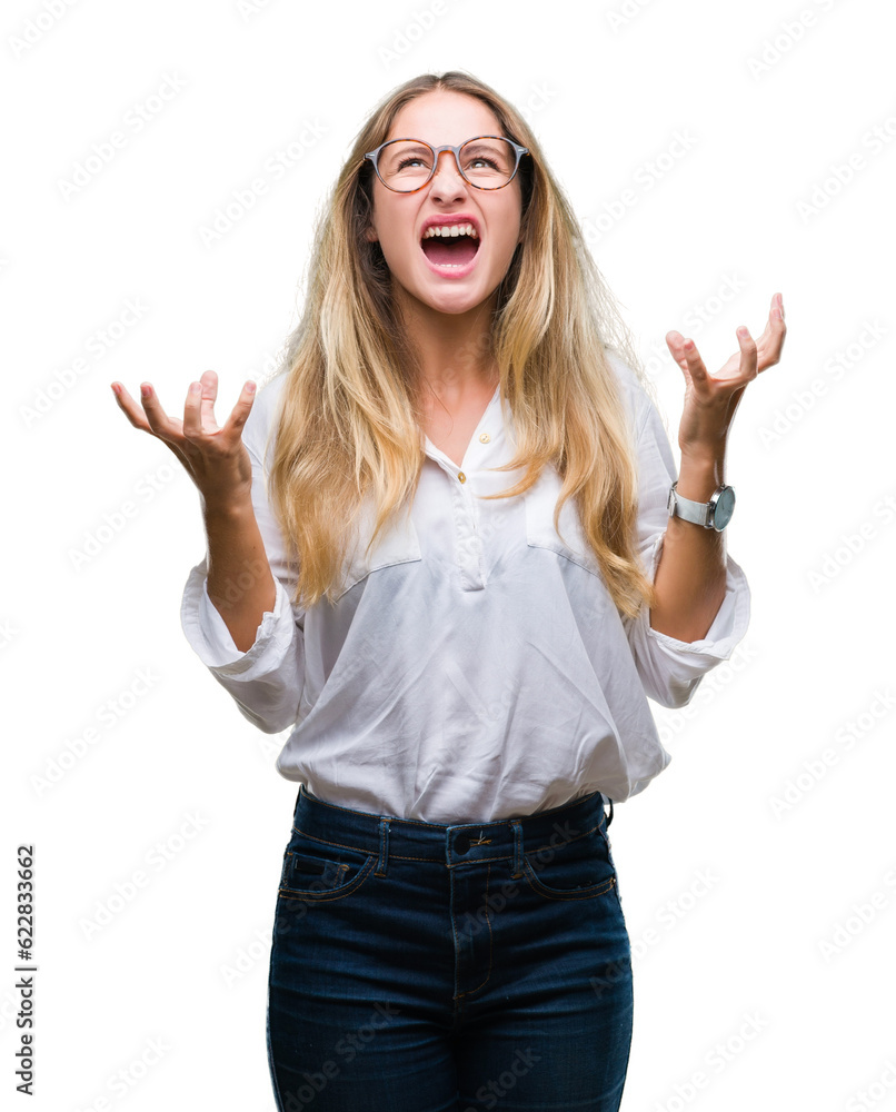 Young beautiful blonde business woman wearing glasses over isolated background crazy and mad shouting and yelling with aggressive expression and arms raised. Frustration concept. Young beautiful blonde business woman wearing glasses over isolated background crazy and mad shouting and yelling with aggressive expression and arms raised. Frustration concept.
