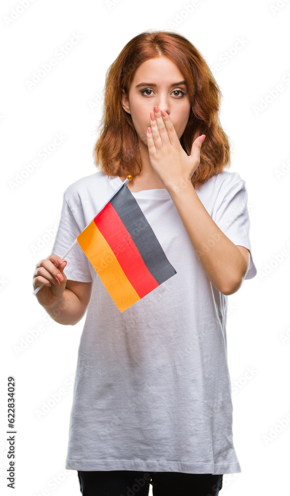 Young beautiful woman holding flag of germany over isolated background cover mouth with hand shocked with shame for mistake, expression of fear, scared in silence, secret concept Young beautiful woman holding flag of germany over isolated background cover mouth with hand shocked with shame for mistake, expression of fear, scared in silence, secret concept