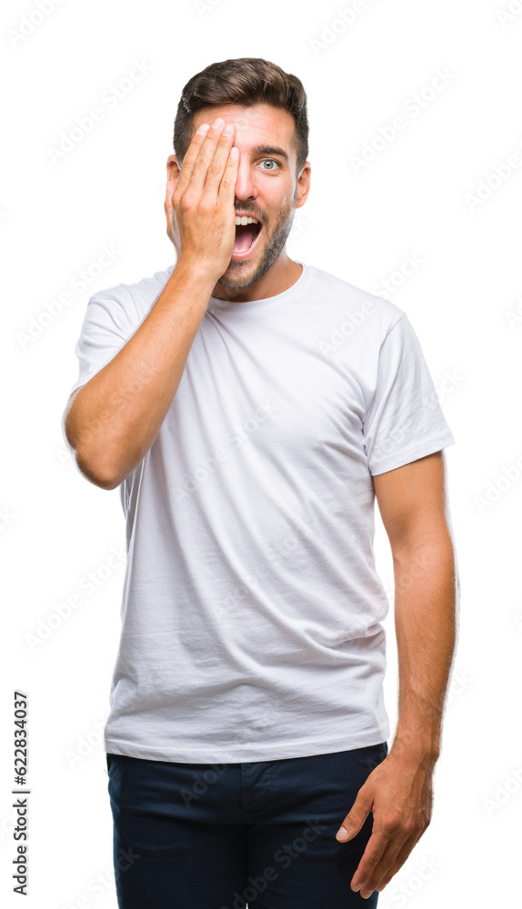 Young handsome man over isolated background covering one eye with hand with confident smile on face and surprise emotion. Young handsome man over isolated background covering one eye with hand with confident smile on face and surprise emotion.
