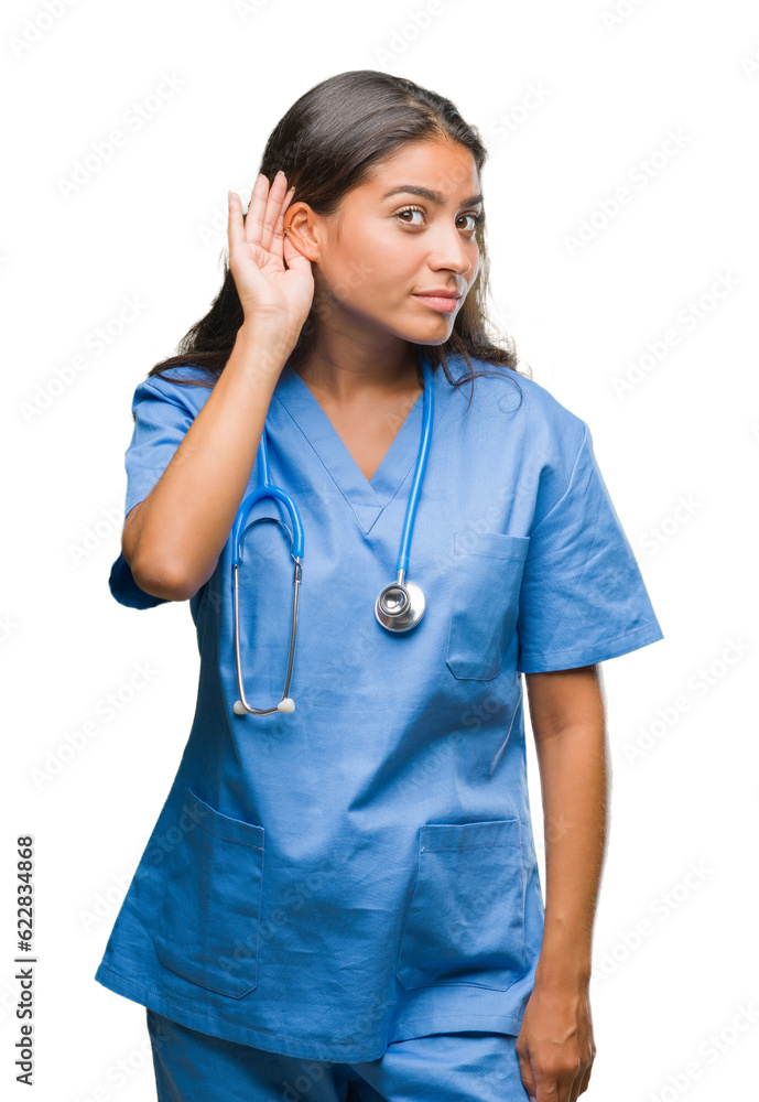 Young arab doctor surgeon woman over isolated background smiling with hand over ear listening an hearing to rumor or gossip. Deafness concept. Young arab doctor surgeon woman over isolated background smiling with hand over ear listening an hearing to rumor or gossip. Deafness concept.