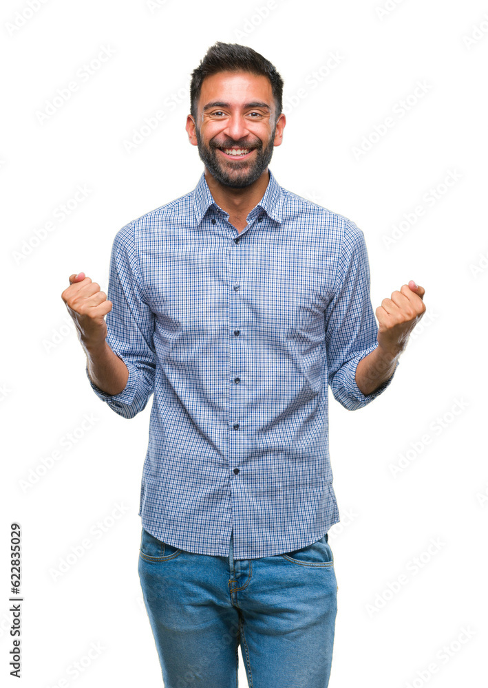 Adult hispanic man over isolated background celebrating surprised and amazed for success with arms raised and open eyes. Winner concept. Adult hispanic man over isolated background celebrating surprised and amazed for success with arms raised and open eyes. Winner concept.