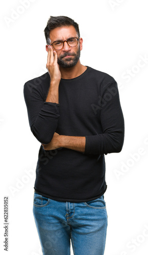 Adult hispanic man wearing glasses over isolated background thinking looking tired and bored with depression problems with crossed arms. © Krakenimages.com