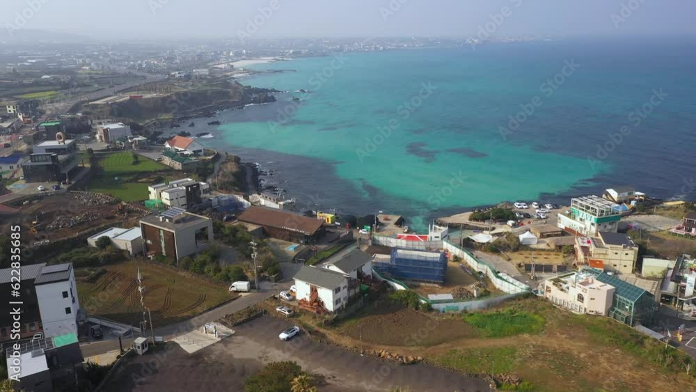 Aerial shot of fields, beach and seaside village,Jeju Island,South Korea Aerial shot of fields, beach and seaside village,Jeju Island,South Korea