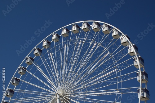 A big wheel against the bright blue sky