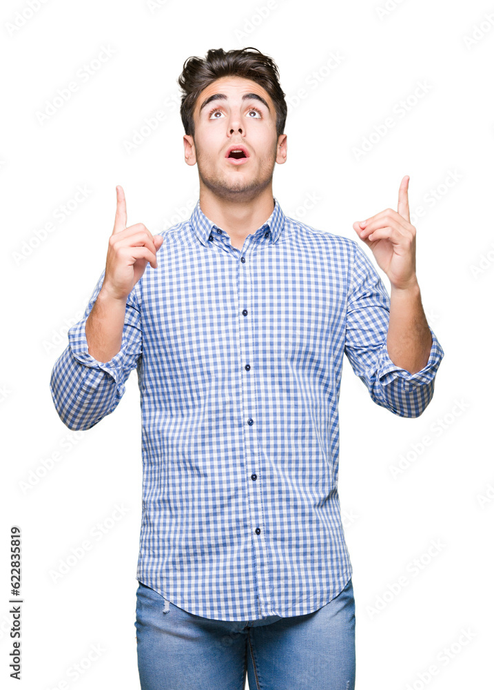 Young handsome business man over isolated background amazed and surprised looking up and pointing with fingers and raised arms. Young handsome business man over isolated background amazed and surprised looking up and pointing with fingers and raised arms.