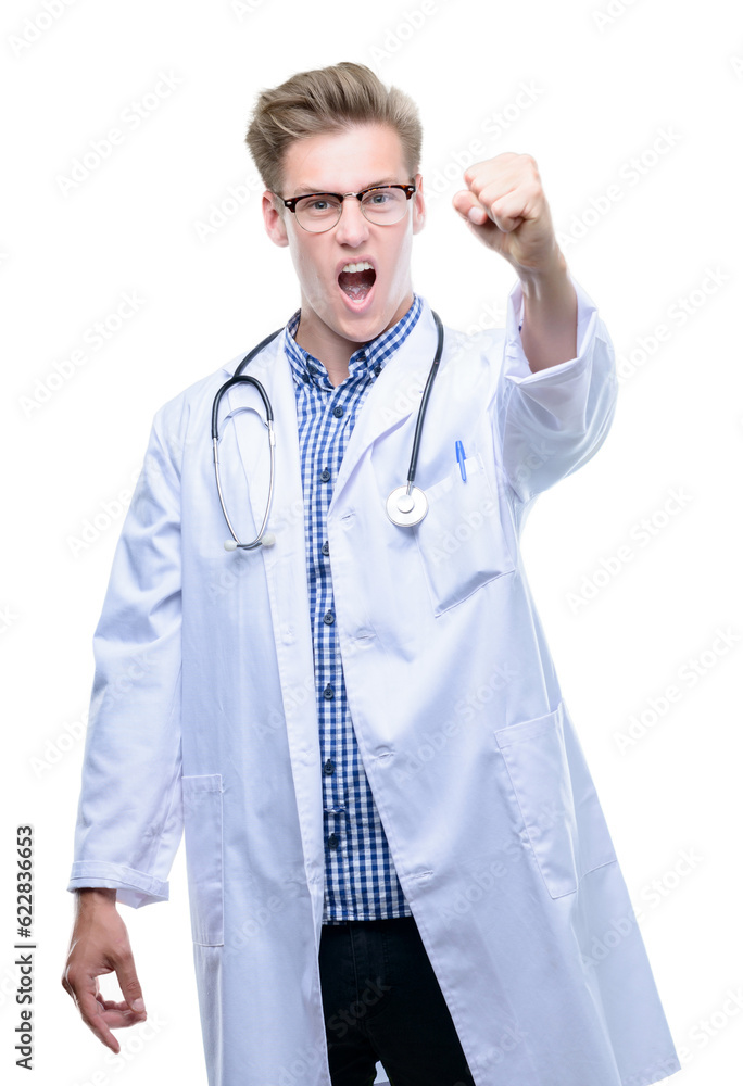 Young handsome blond doctor annoyed and frustrated shouting with anger, crazy and yelling with raised hand, anger concept Young handsome blond doctor annoyed and frustrated shouting with anger, crazy and yelling with raised hand, anger concept