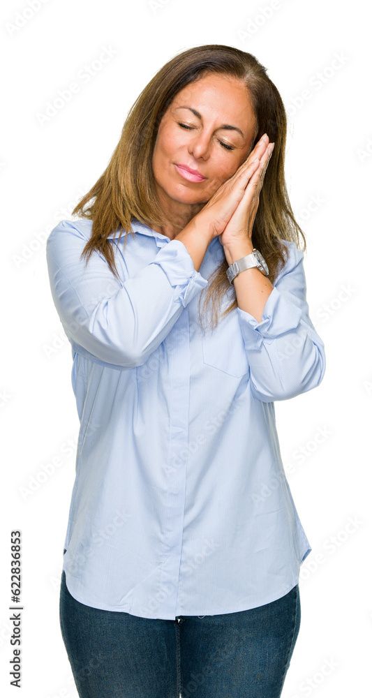 Beautiful middle age business adult woman over isolated background sleeping tired dreaming and posing with hands together while smiling with closed eyes. Beautiful middle age business adult woman over isolated background sleeping tired dreaming and posing with hands together while smiling with closed eyes.