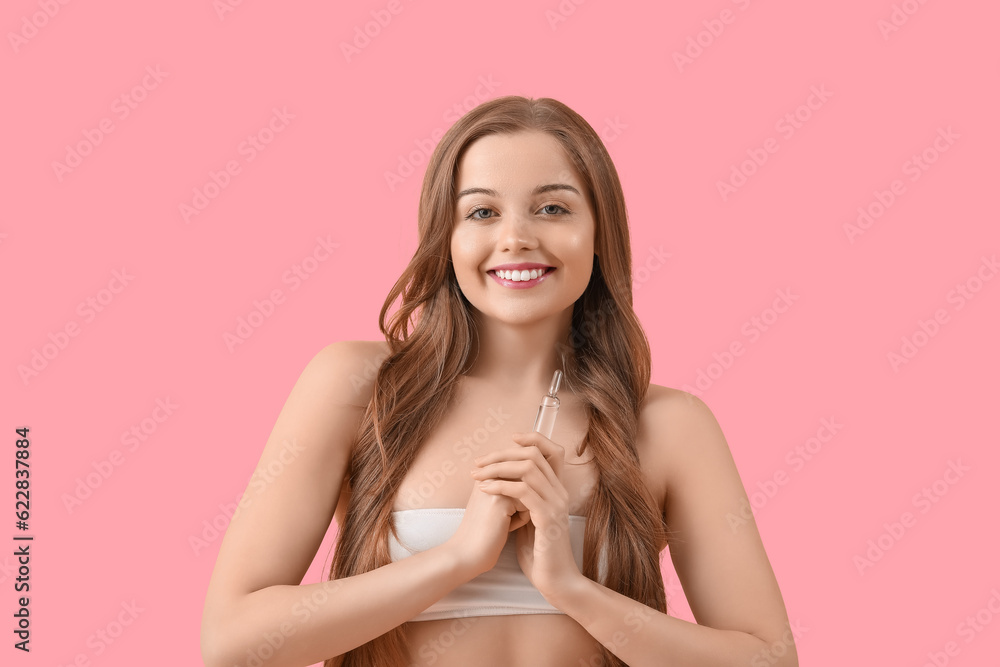 Beautiful young woman with ampule on pink background. Skin care concept Beautiful young woman with ampule on pink background. Skin care concept
