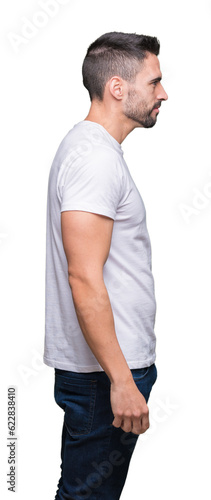 Young man wearing casual white t-shirt over isolated background looking to side, relax profile pose with natural face with confident smile.