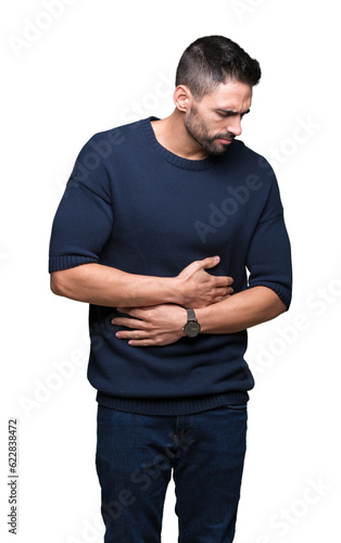 Young handsome man wearing sweater over isolated background with hand on stomach because nausea, painful disease feeling unwell. Ache concept.