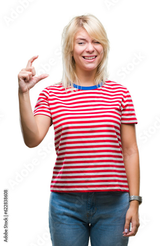 Young beautiful blonde woman over isolated background smiling and confident gesturing with hand doing size sign with fingers while looking and the camera. Measure concept.