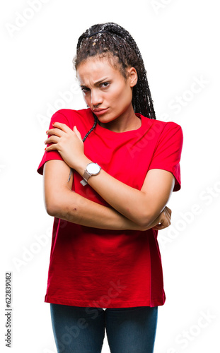 Young braided hair african american girl over isolated background skeptic and nervous, disapproving expression on face with crossed arms. Negative person.