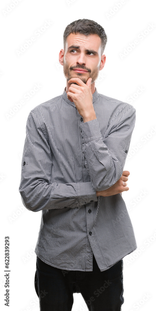 Young hipster man with hand on chin thinking about question, pensive expression. Smiling with thoughtful face. Doubt concept. Young hipster man with hand on chin thinking about question, pensive expression. Smiling with thoughtful face. Doubt concept.