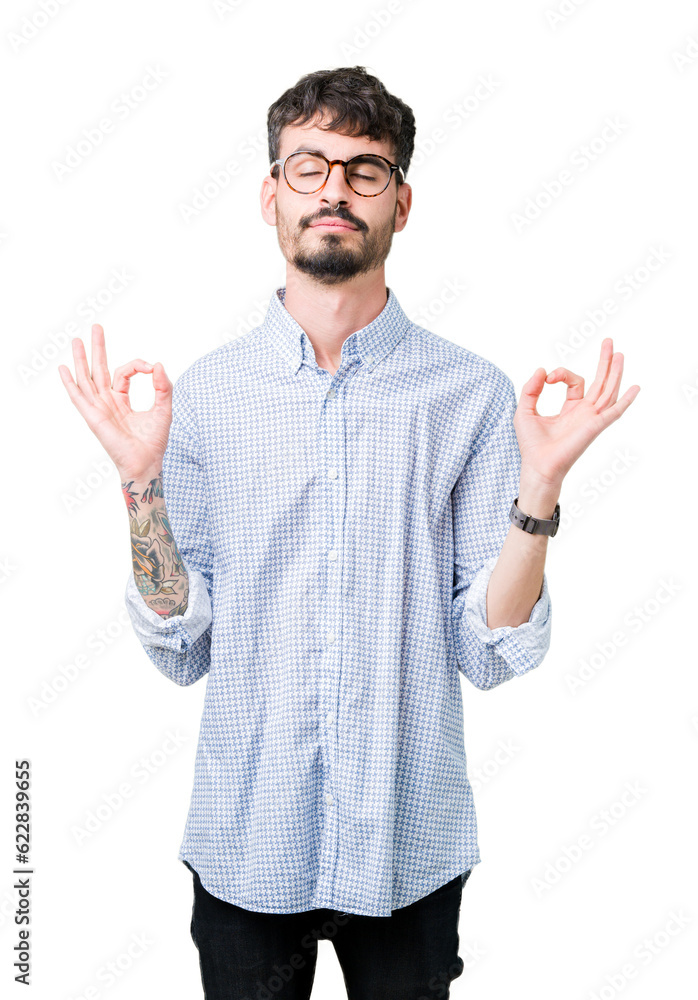 Naklejka premium Young handsome man wearing glasses over isolated background relax and smiling with eyes closed doing meditation gesture with fingers. Yoga concept.