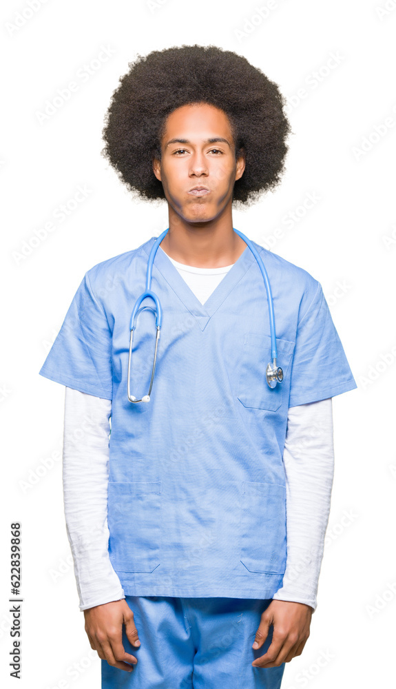 Young african american doctor man with afro hair puffing cheeks with funny face. Mouth inflated with air, crazy expression. Young african american doctor man with afro hair puffing cheeks with funny face. Mouth inflated with air, crazy expression.