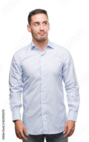 Handsome young businessman smiling looking side and staring away thinking.