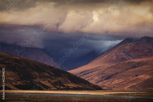 Moody alpine sunset at base of mountains