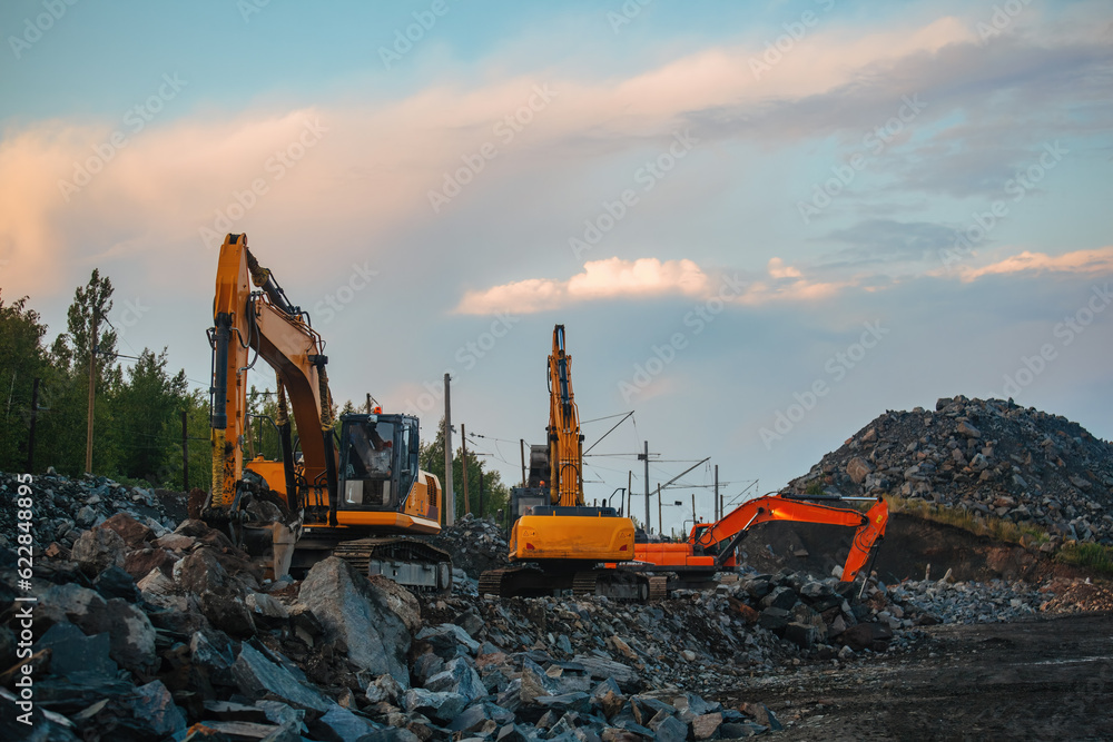 Excavators working on earthmoving at open pit mine in mining and processing plant
